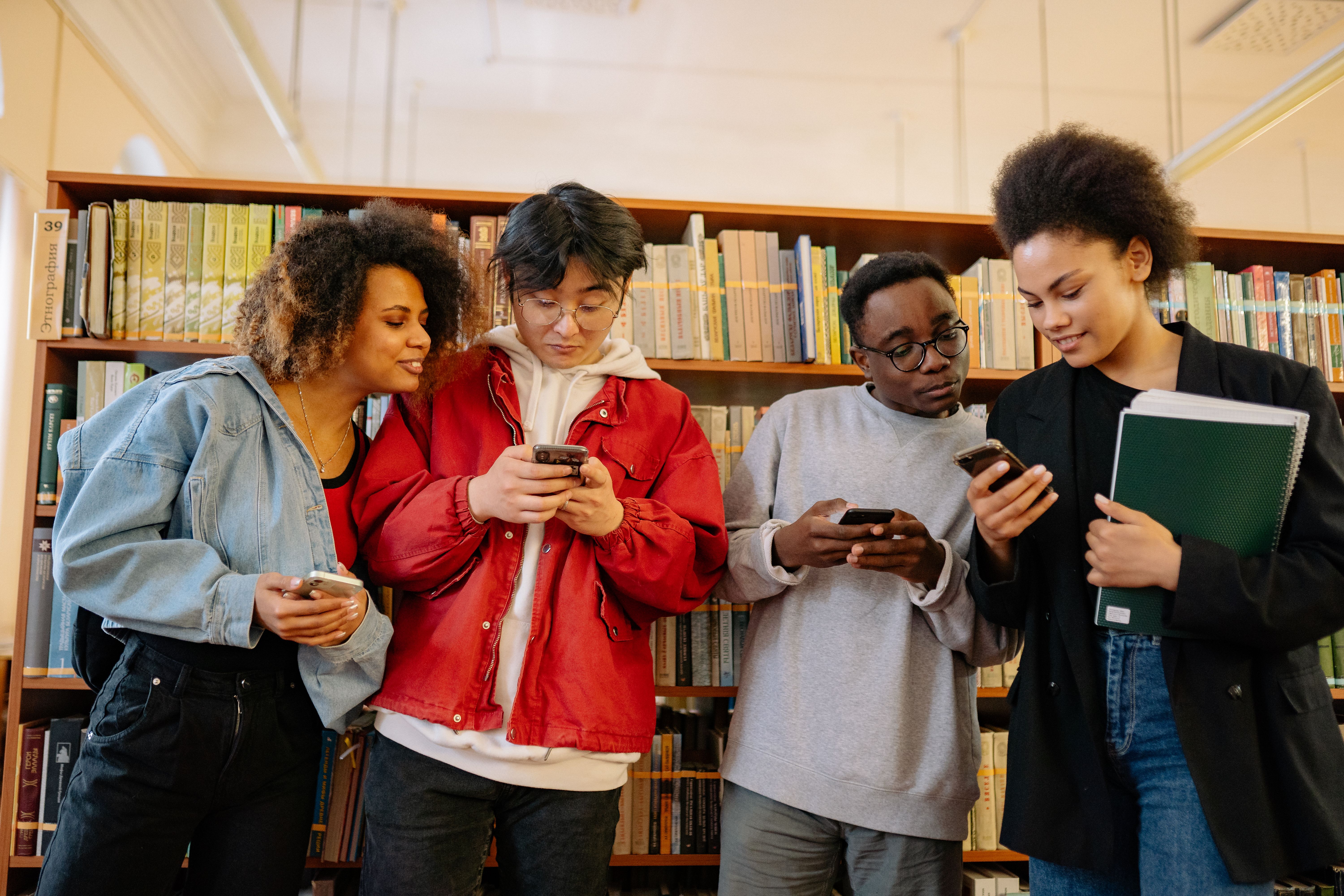 Students in a student center on a phone